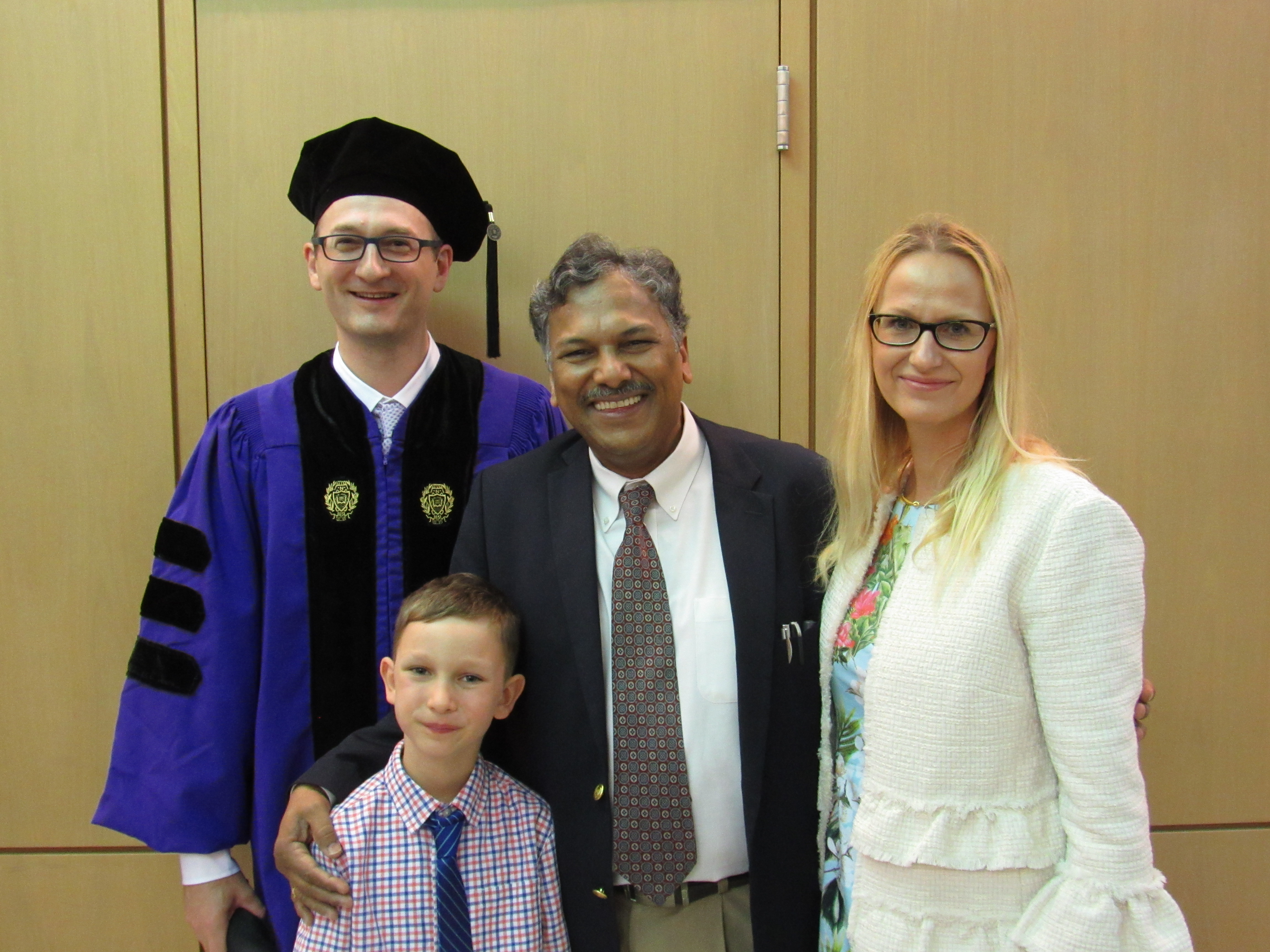 Professor Dravid poses with the Myers family at a commencement celebration in Cook Hall