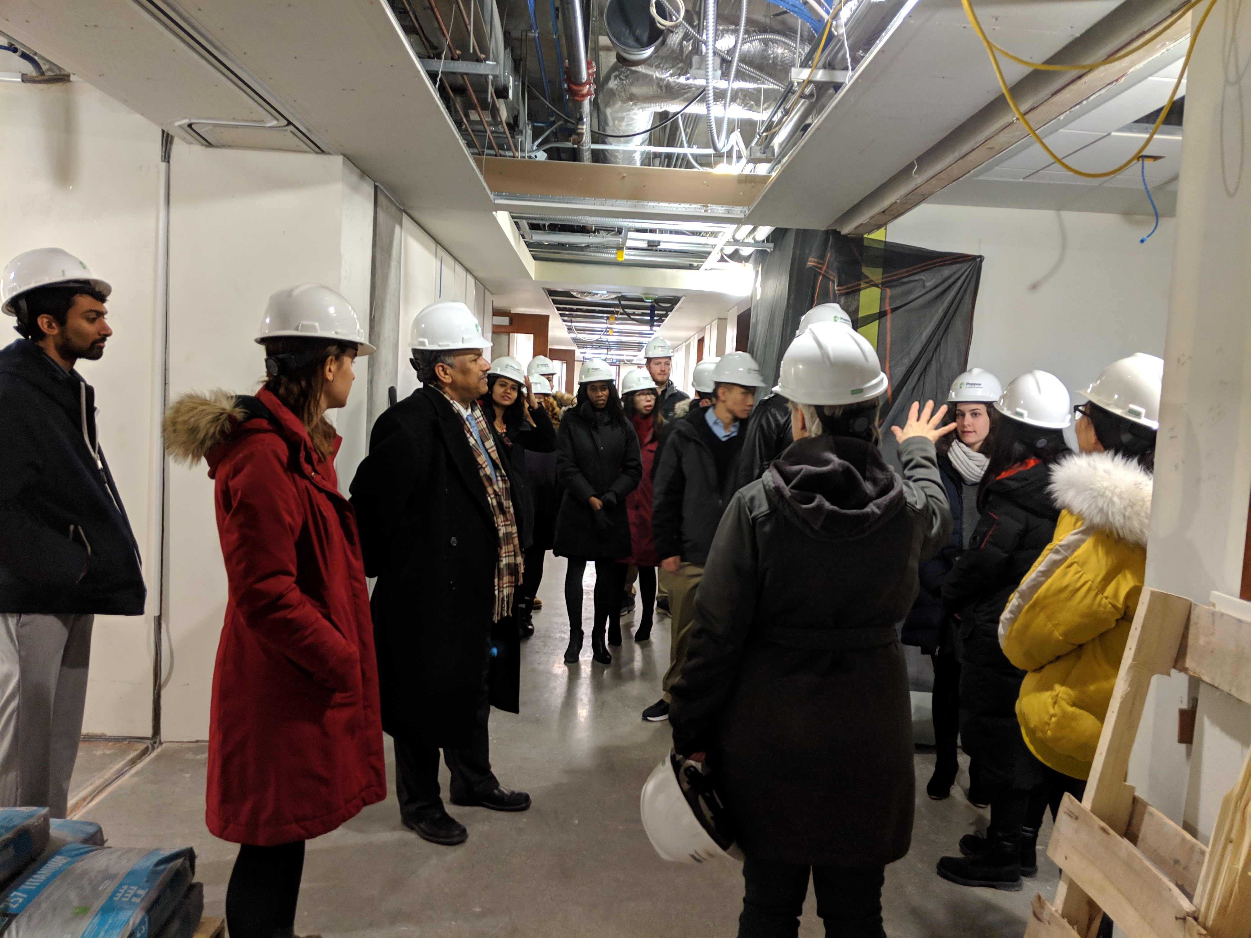 Construction workers walked the group through their new space.